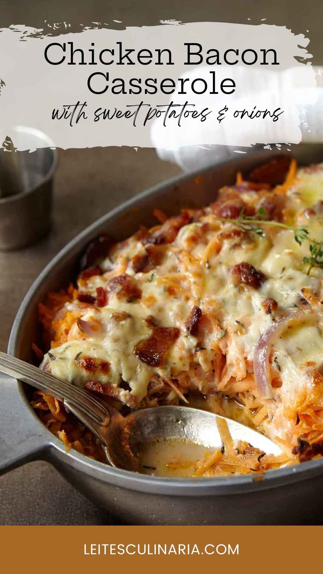 A chicken, sweet potato, and bacon casserole in an oval dish, topped with melted cheese.