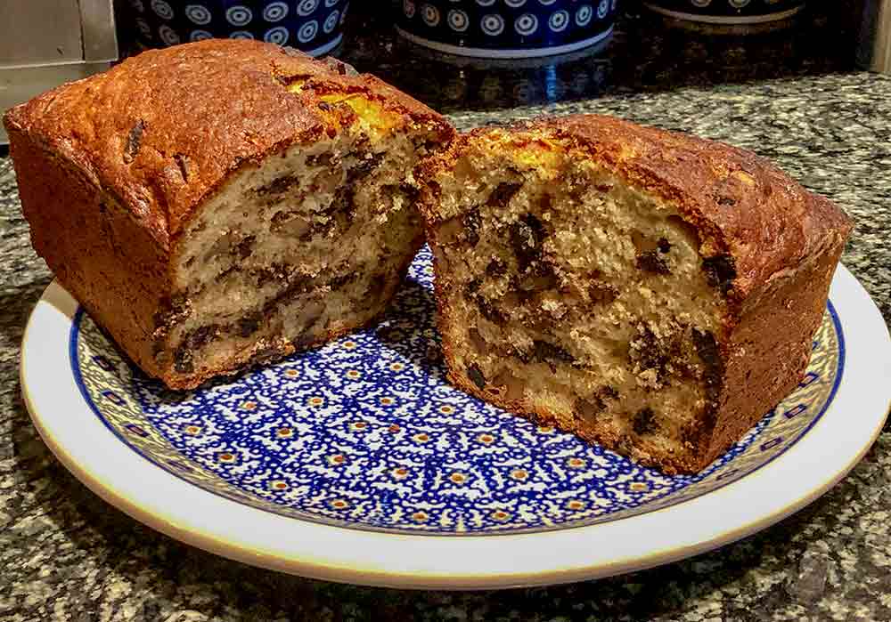 a loaf of chocolate-bourbon-spiked banana bread sliced open to revel chocolate speckled interior