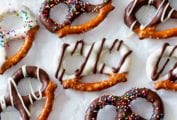 An assortment of chocolate covered pretzels with white and dark chocolate coating and sprinkles
