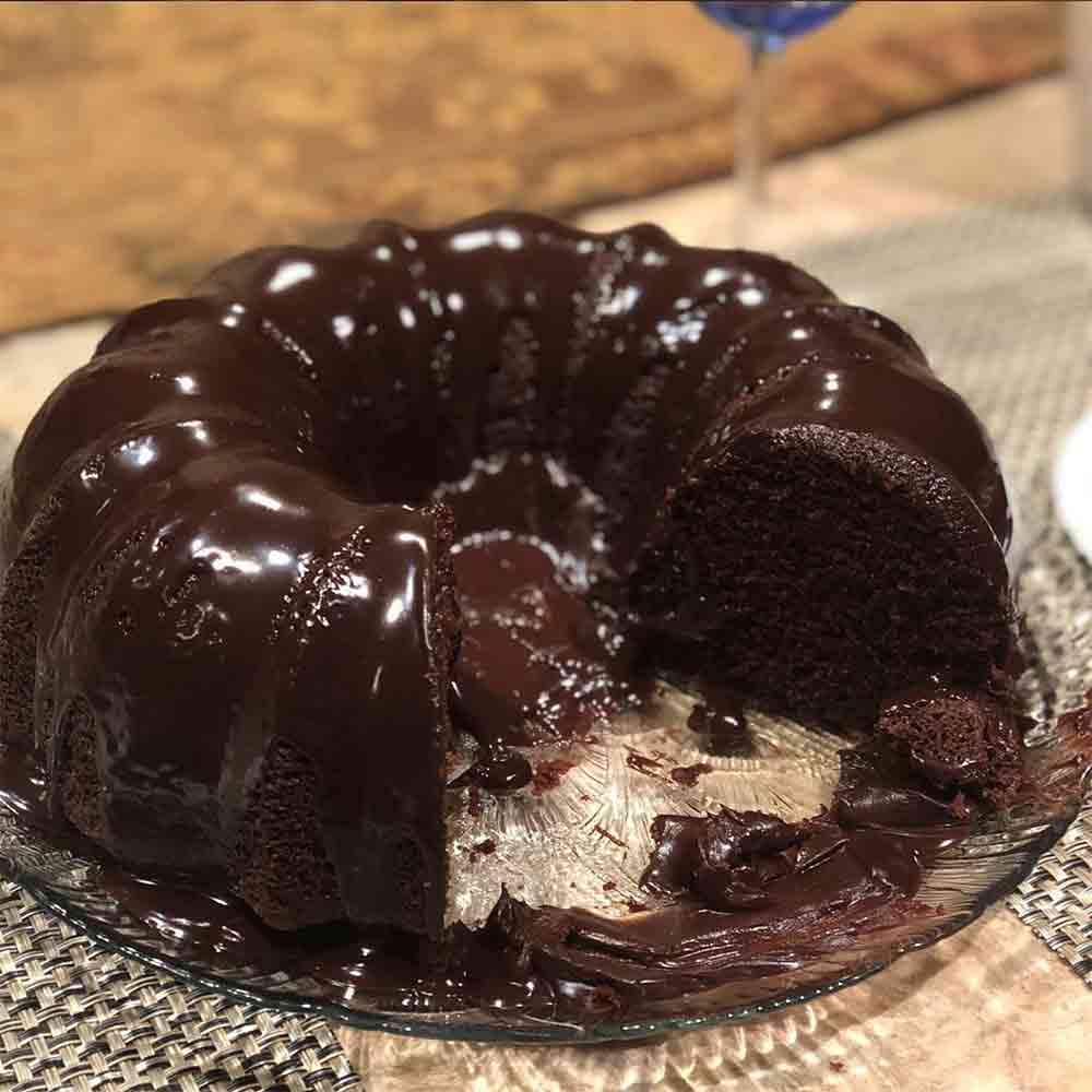 A chocolate sour cream Bundt cake topped with a rich, thick chocolate ganache