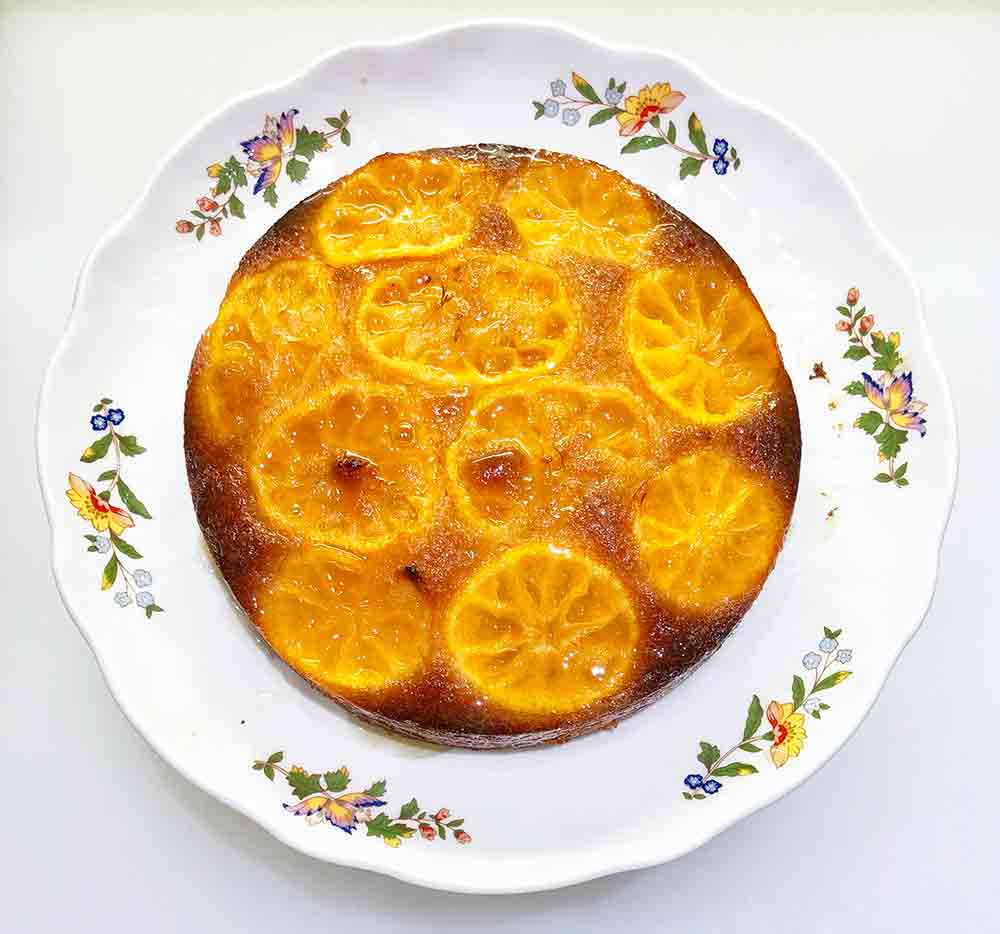 An upside-down clementine cake, with golden slices of clementines showing