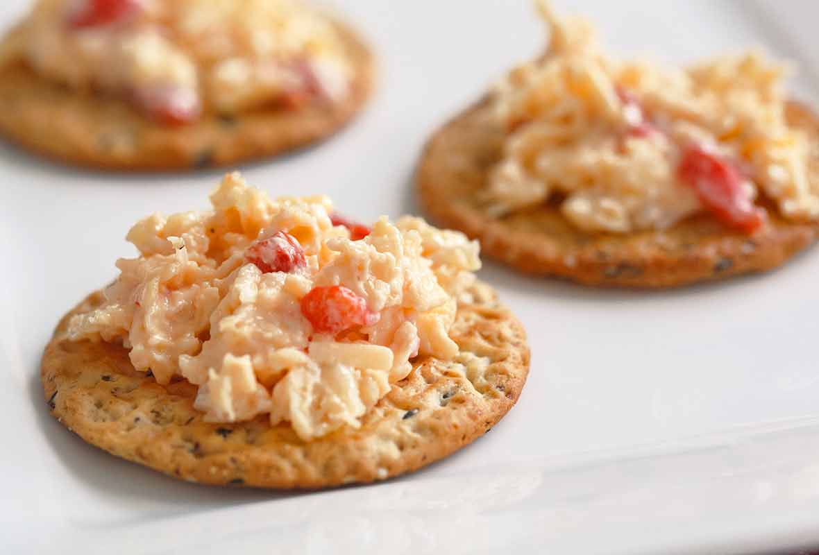 Crackers topped with pimento cheese.