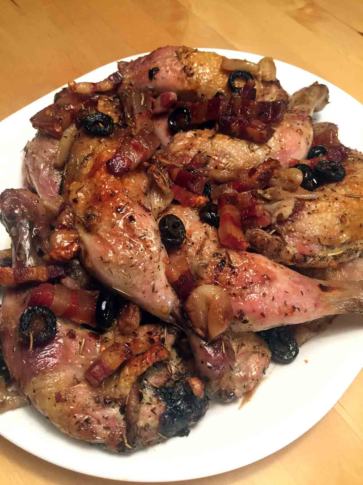 A platter of roast chicken with pancetta and olives