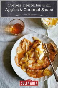 A white plate filled with crêpes dentelles with sautéed apples and caramel sauce