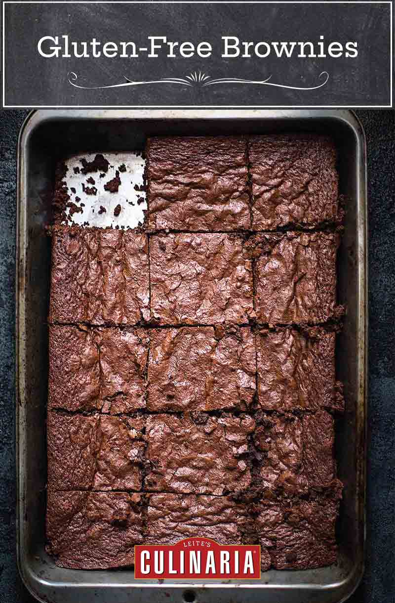 A metal baking pan of gluten free brownies with one piece missing