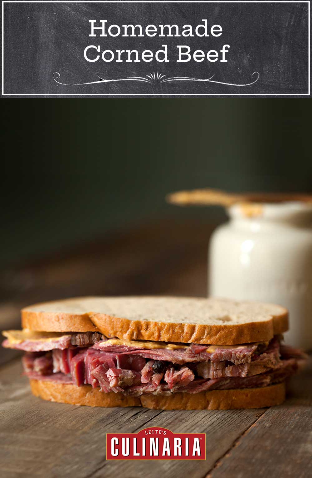 Several slices of homemade corned beef in a sandwich on a wooden table.