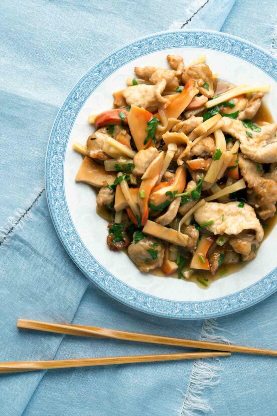 A blue and white plate filled with moo goo gai pan