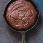 A cast-iron skillet filled with chocolate brownie.