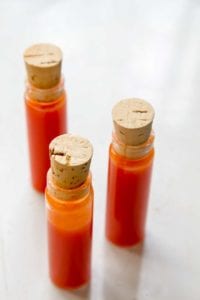 Three corked vials of homemade hot sauce.