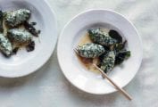 Two bowls, each with three spinach and ricotta gnudi and several fried sage leaves