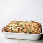 A white baking dish filled with zucchini strata