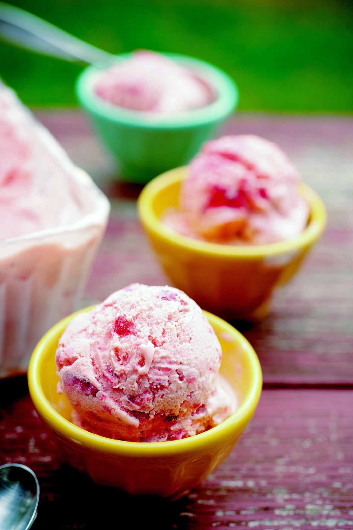 Three bowls of strawberry ice cream.