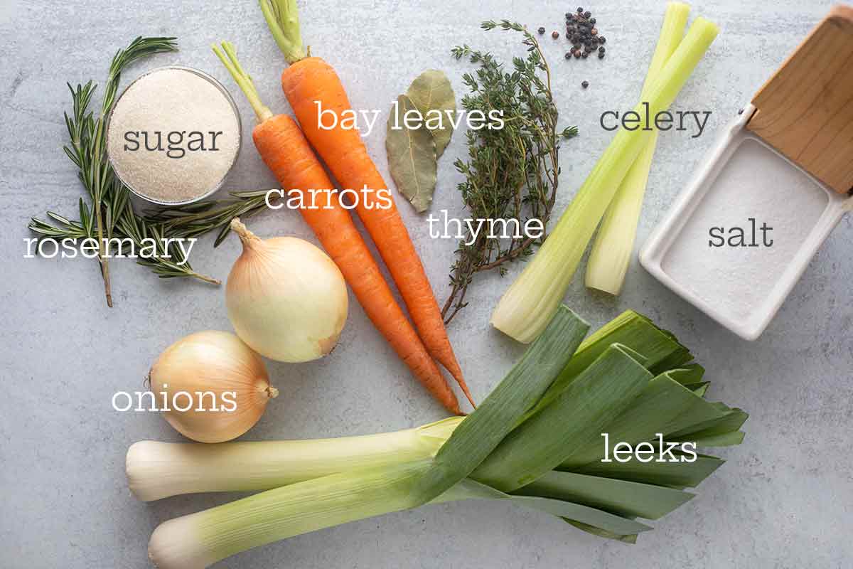 Two carrots, two onions, two bay leaves, two leaks, two sprigs of rosemary, thyme, celery, salt, and pepper for making the brine for the better brined roast chicken.