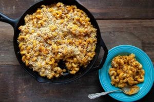 A cast-iron skillet filled with pumpkin mac and cheese