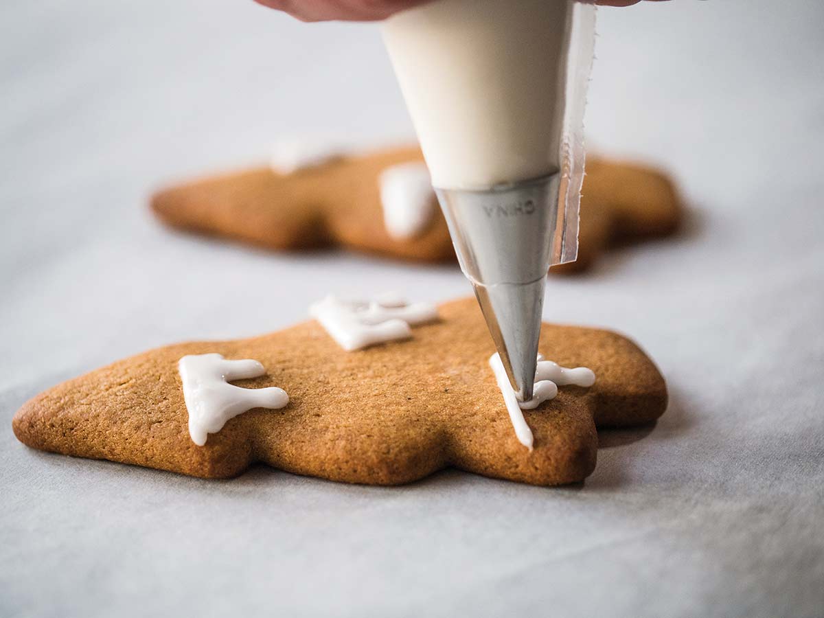 Cookies being decorated with royal icing.