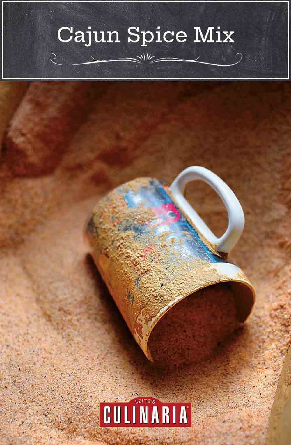 A mug lying on its side in a bin of cajun spice mix.