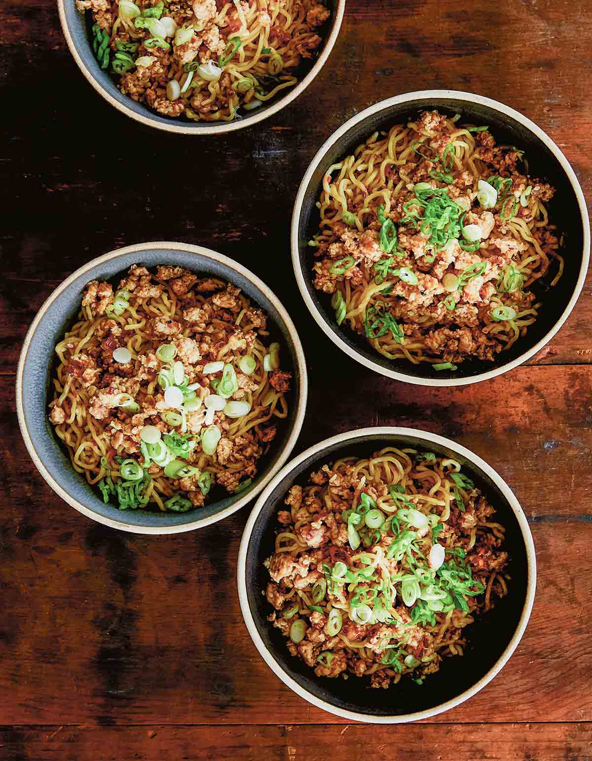 Three bowls of chicken dan dan noodles with Sichuan tare.