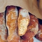A paper bag filled with loaves of pane Francese.