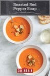 Two bowls of roasted red pepper soup, topped with croutons and thyme leaves.