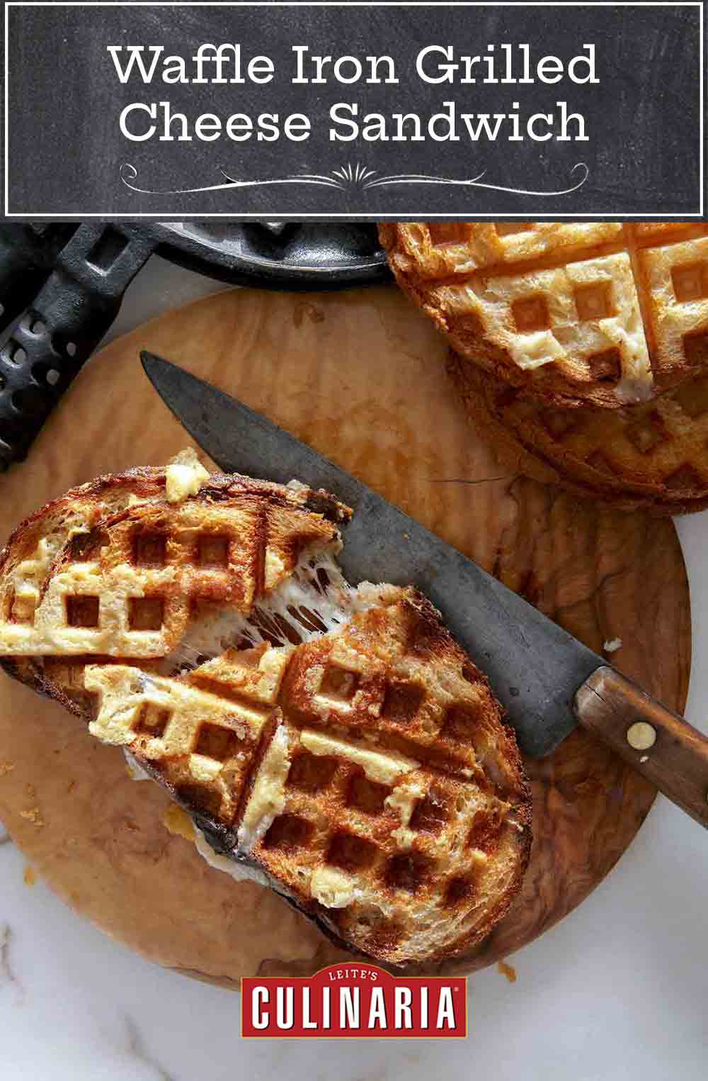 Two grilled cheese sandwiches, made in a waffle iron, on a cutting blade with a knife and waffle iron