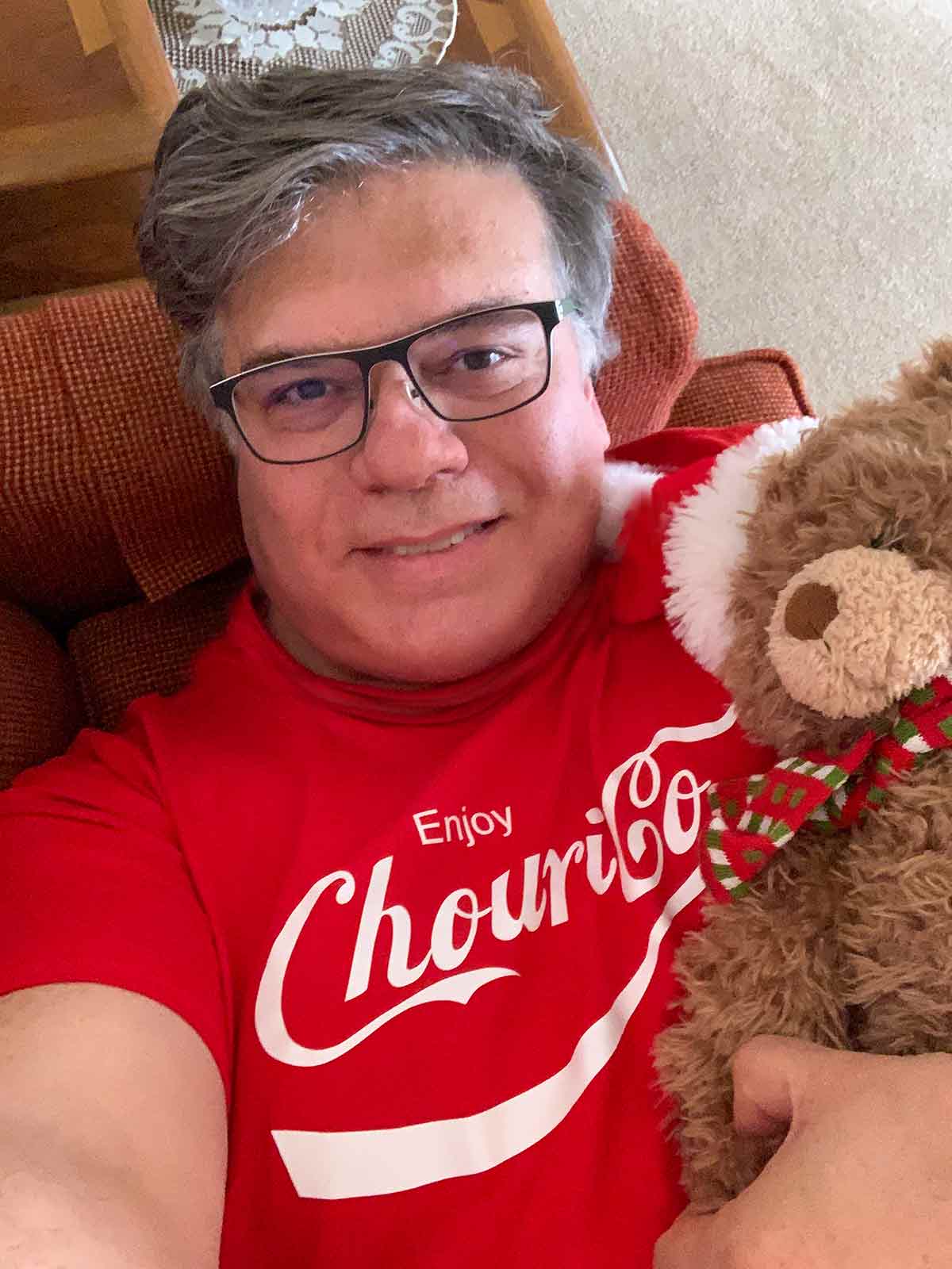 David is enjoying some down-home hygge wearing his favorite t-shirt while snuggled on the couch with a stuffed animal.