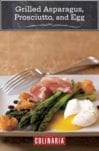 Grilled asparagus, prosciutto, fried bread, and poached egg on a white plate with a fork resting on the side.