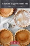 Four Hoosier sugar cream pies, one dusted with confectioners' sugar on a sheet of parchment.