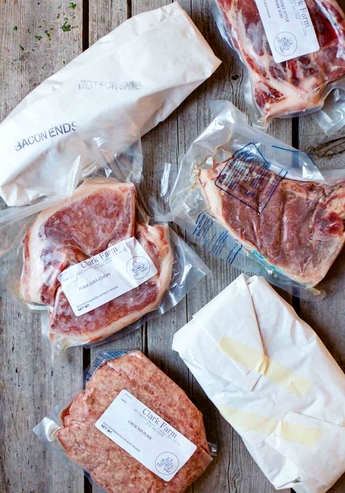 Several packages of frozen meat that need instruction on how to defrost meat safely.
