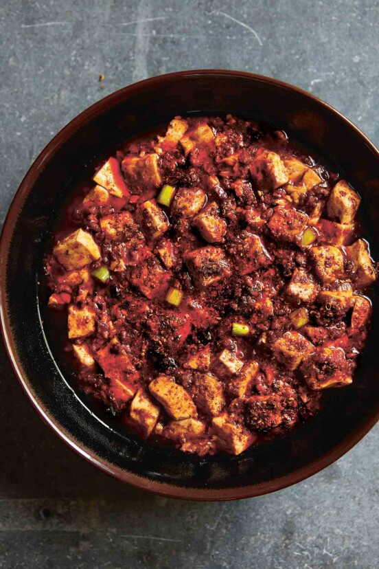 A brown ceramic bowl filled with mapo tofu.