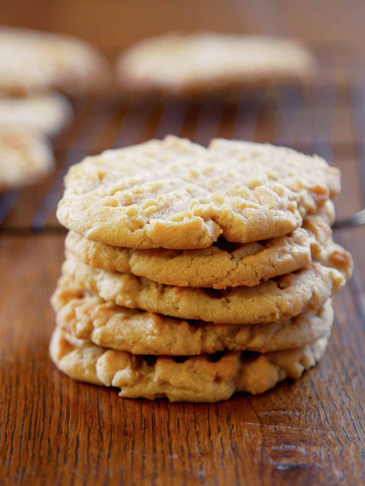 A stack of five old-fashioned peanut butter cookies, with crosshatch marks on top