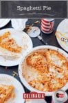 A white dish with a partially cut spaghetti pie, two paper plates with slices of spaghetti pie, a pizza cutter, napkins, and two cans of beer.