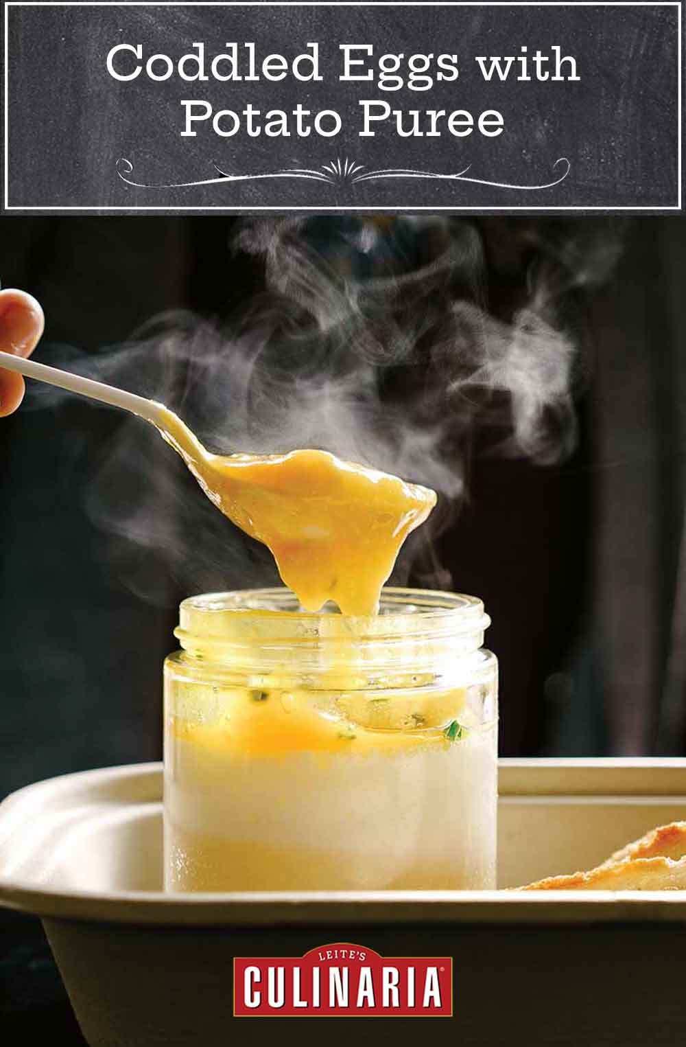 Person with a spoon digging into a glass jar of coddle eggs with potato puree underneath, slice of bread nearby