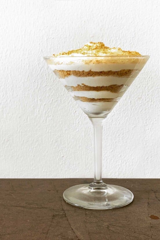 A serving of Portuguese sawdust pudding layered in a martini glass.