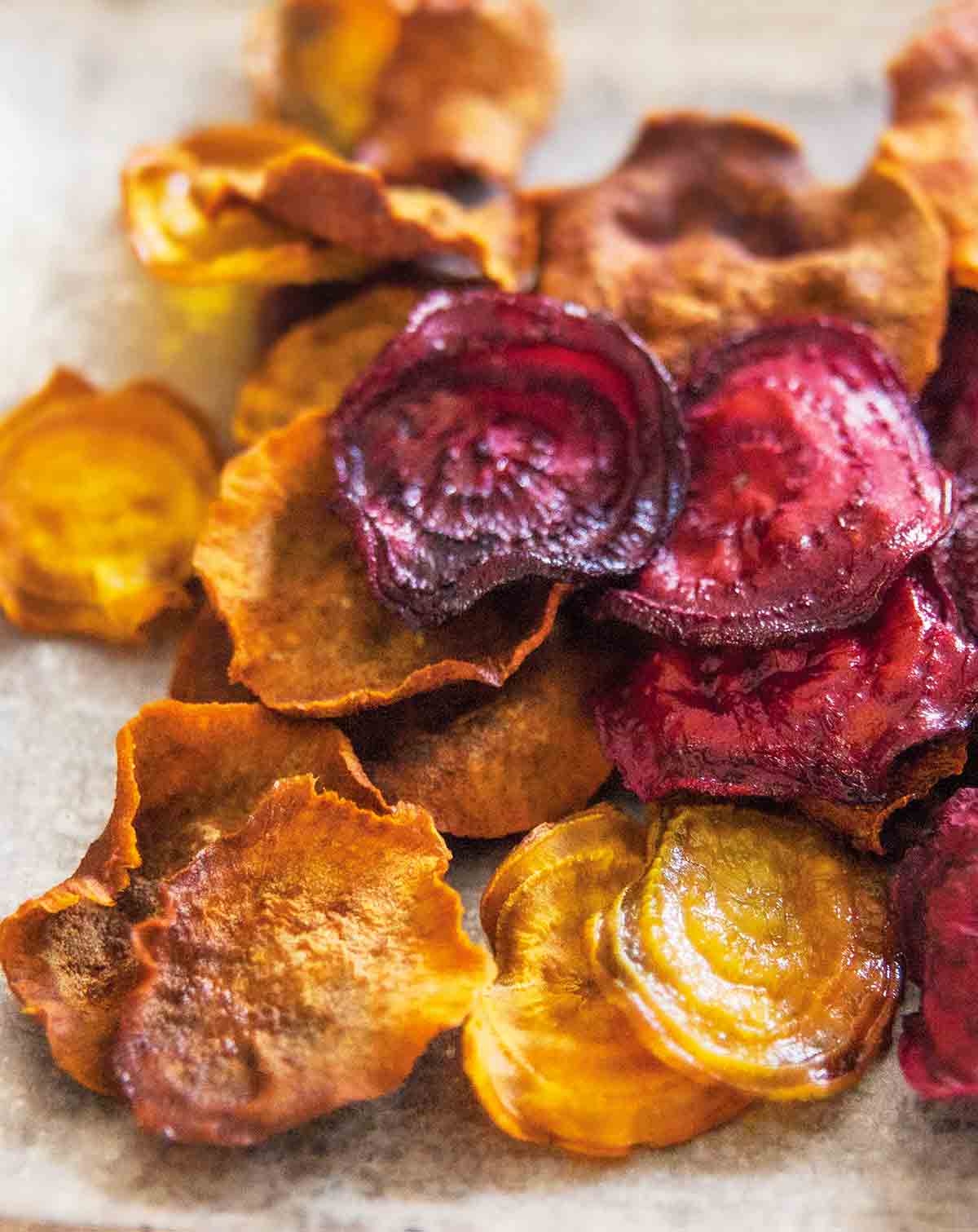 A pile of beet and sweet potato root vegetable chips.