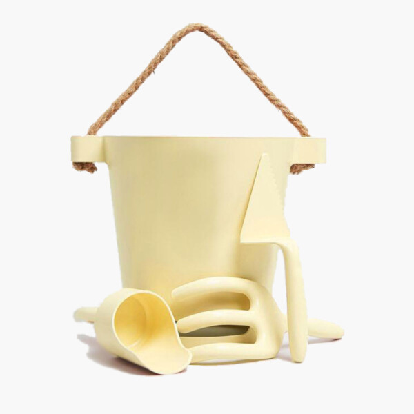 A yellow pail and shovel set with a rope handle.