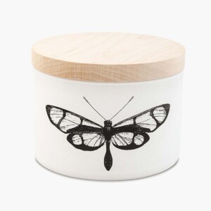 A citronella candle in a white jar decorated with a butterfly and a wooden lid.