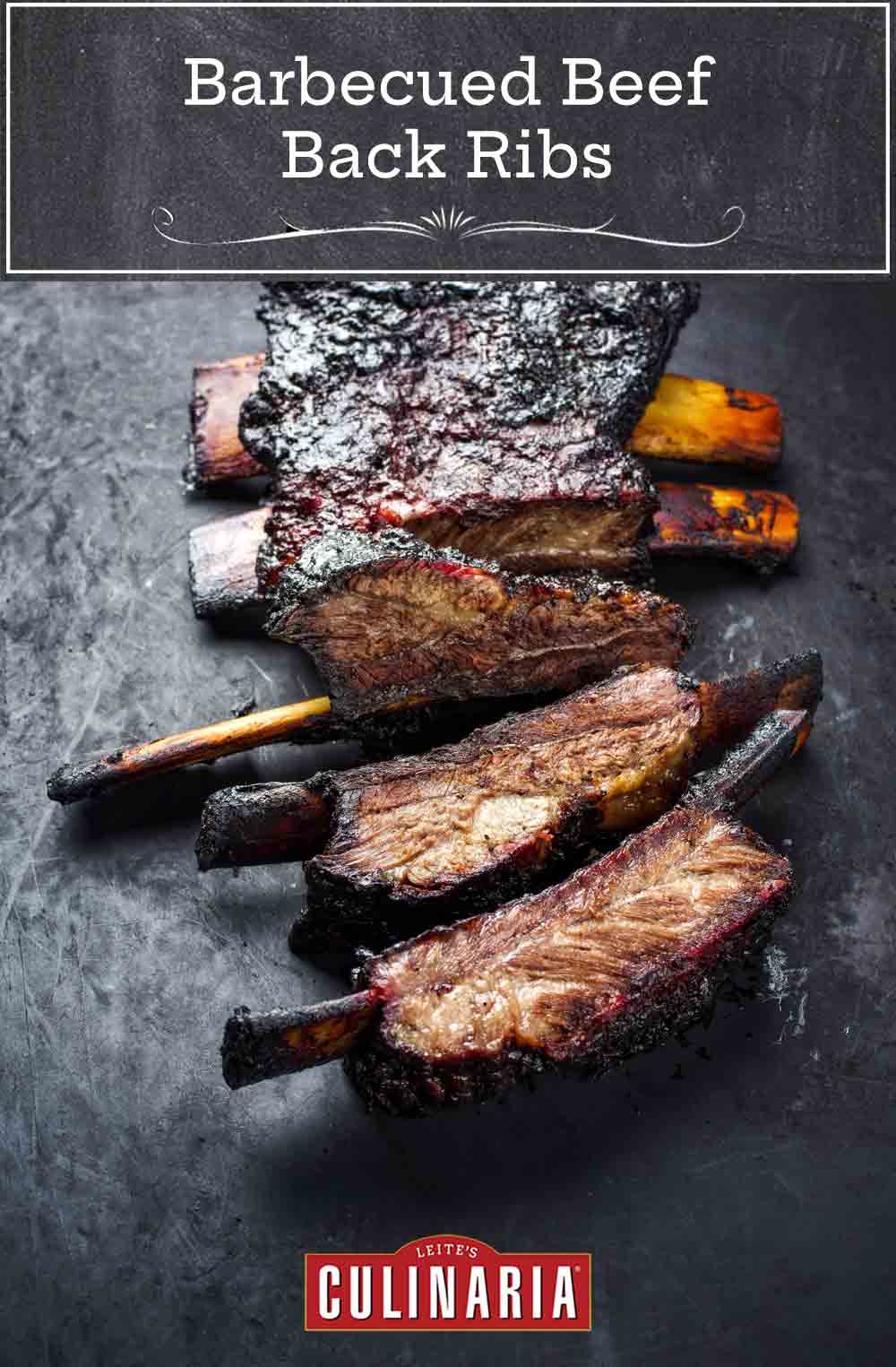 A slab of barbecued beef back ribs cut into individual ribs.