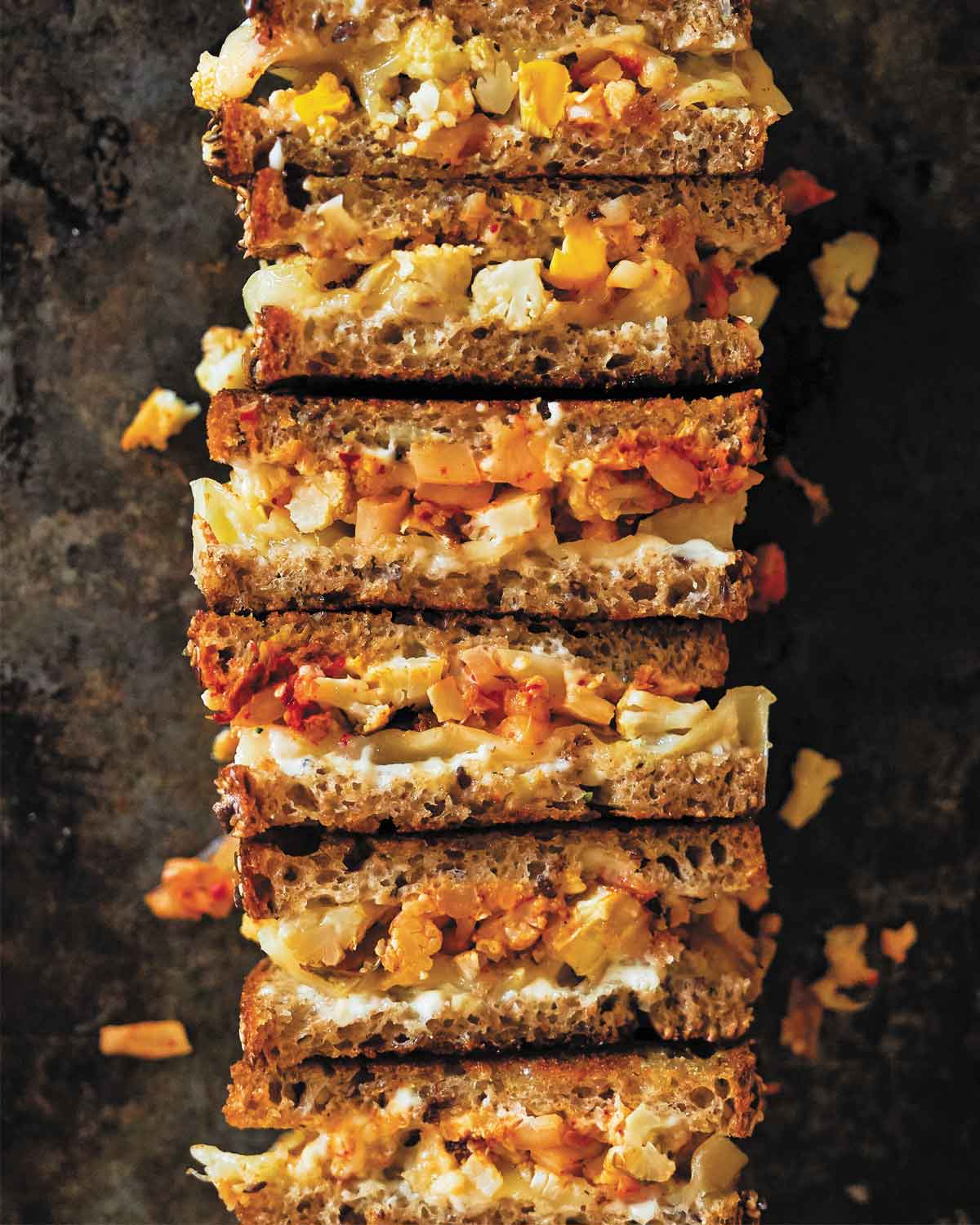 Six sections of cauliflower and kimchi sandwiches cut to show the filling.