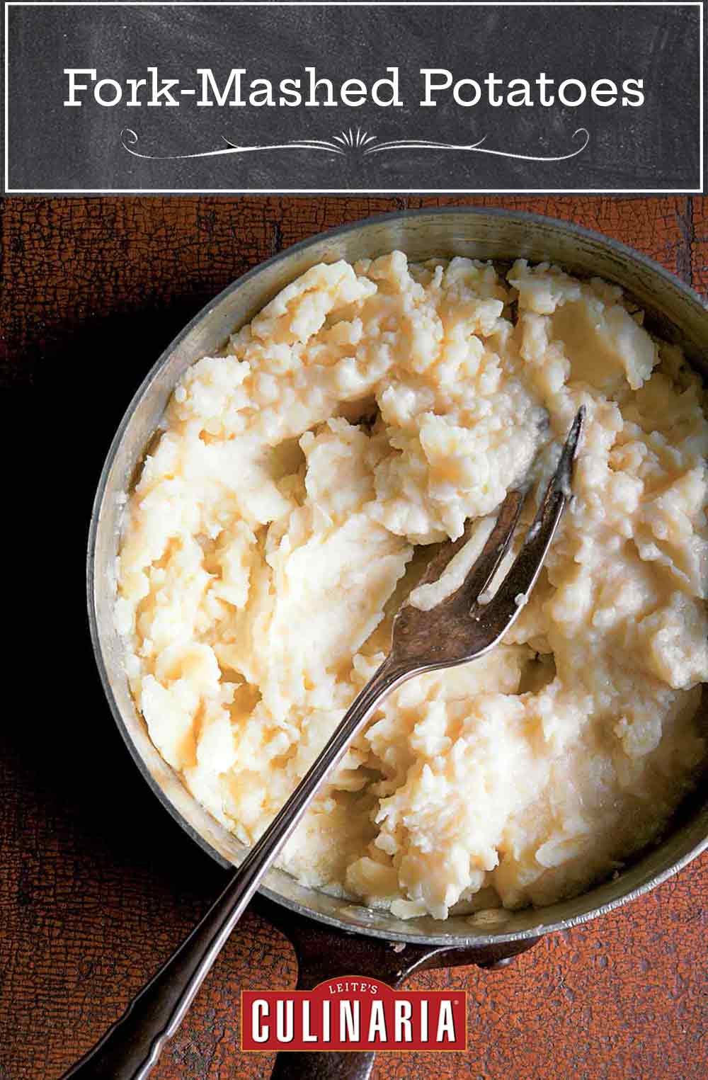 A pot of fork-mashed potatoes with a fork resting inside.
