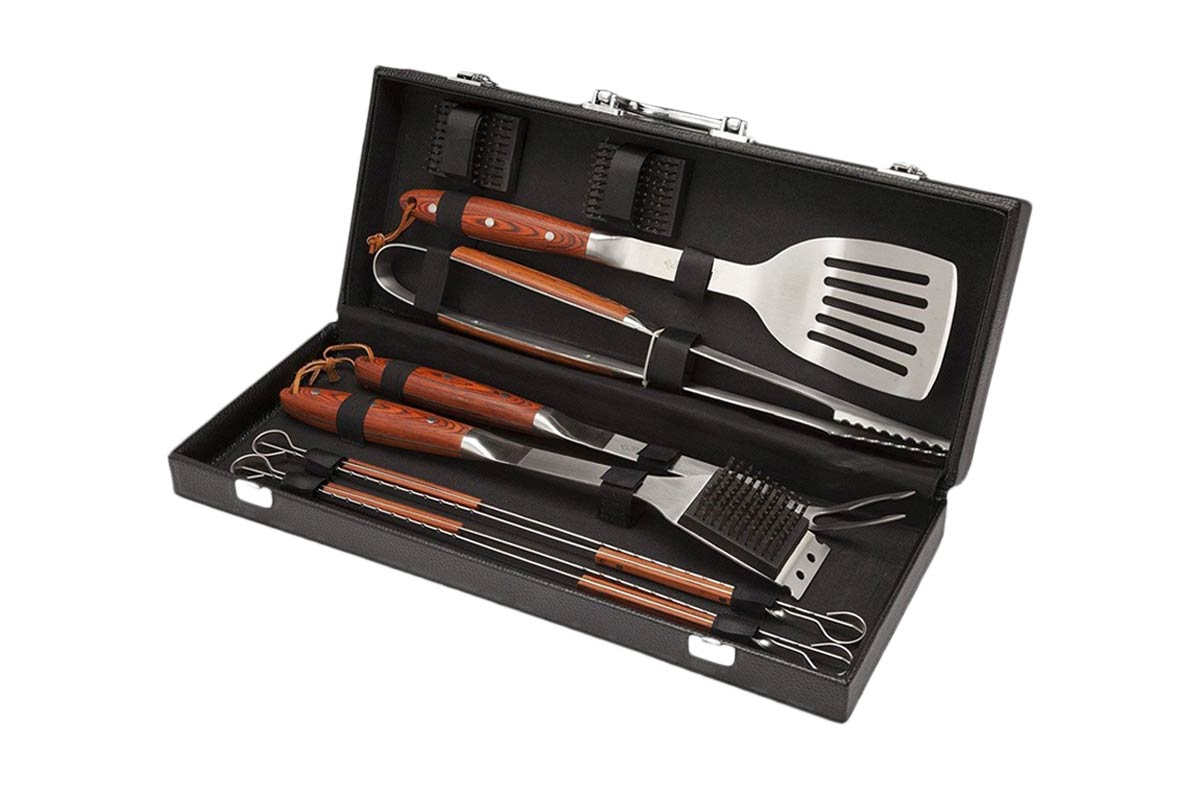 A grilling tool set with spatula, tongs, brush, and skewers.
