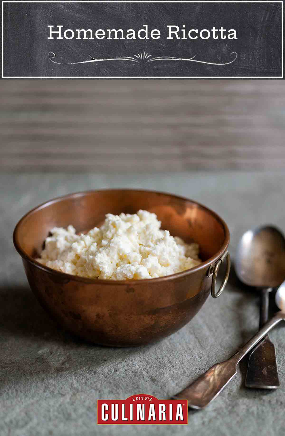 A bowl filled with fresh whole milk ricotta and a spoon on the side.