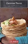 A stack of flour tortillas topped with pork for carnitas tacos.