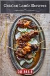Catalan lamb skewers on sliced cucumbers topped with a romesco sauce