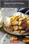 Bowl of batter-covered easy fried pickles with a jar of dipping sauce nearby