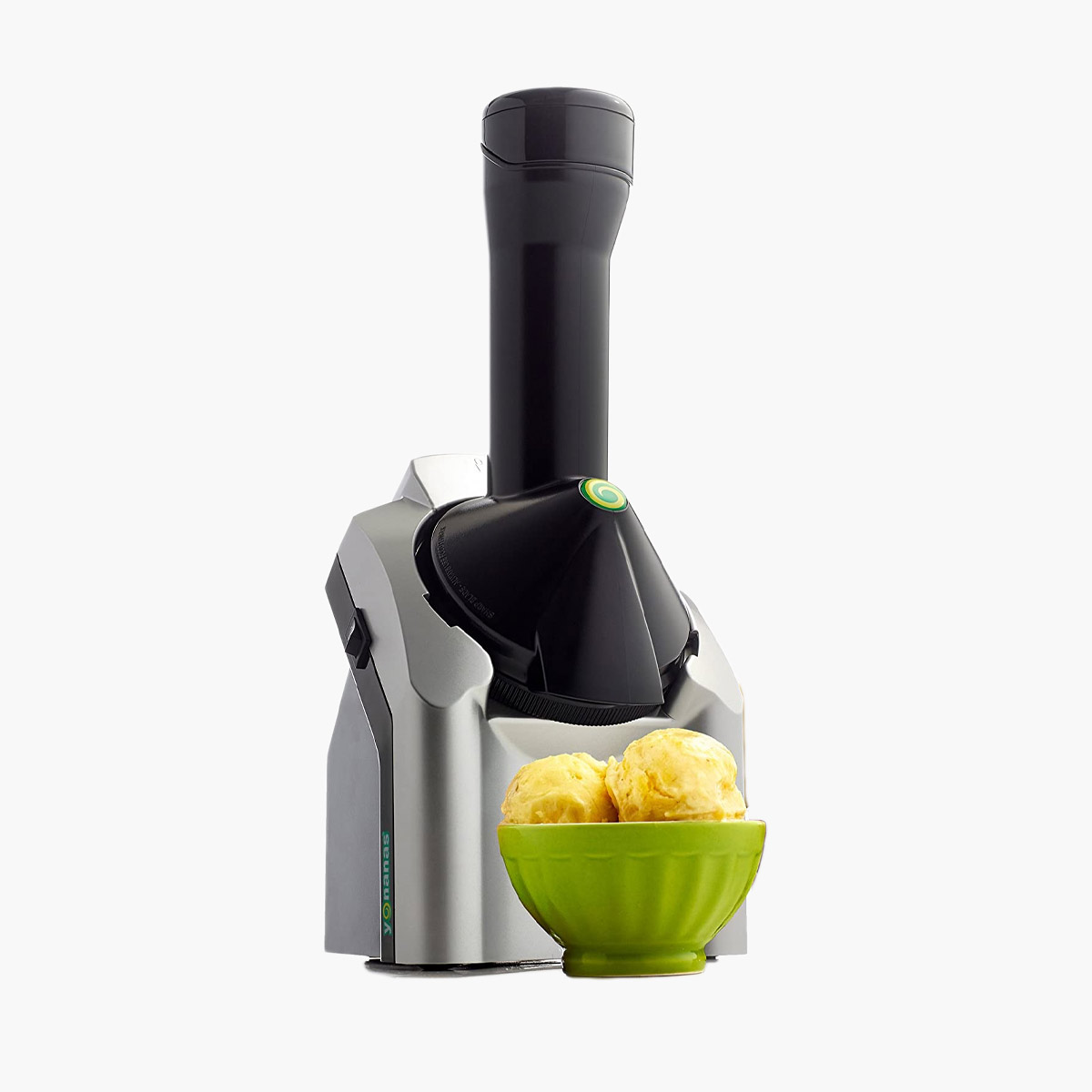 A Yonanas fruit soft serve maker with a bowl of homemade yellow soft serve in front of it.