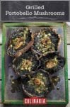 A metal platter holding five grilled portobello mushrooms, topped with garlic rosemary butter.