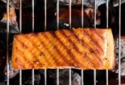 A piece of grilled salmon on an open grill to how how to grill salmon.