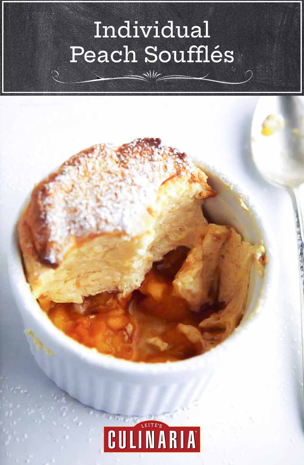 White dish of a sugar-dusted individual peach souffle; in the bottom are peach slices