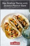 Three tacos with sea scallops and jicama-peanut slaw on a white plate.