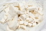 Cubes of fresh homemade paneer in a white cloth.